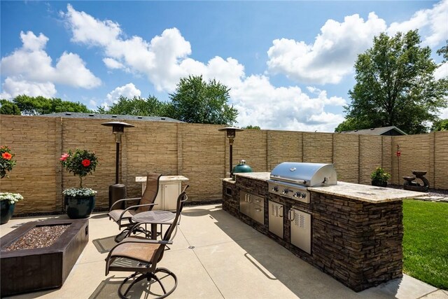 1003 Flame Ave, Effingham, IL 62401 - fenced backyard with area for grilling, a patio, and an outdoor fire pit
