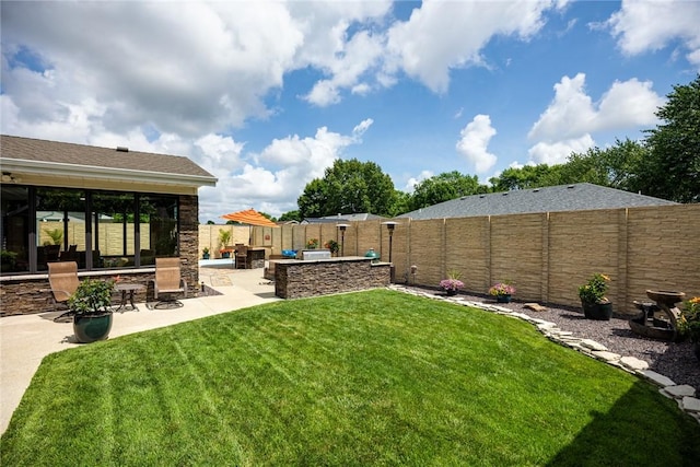 1003 Flame Ave, Effingham, IL 62401 - fenced backyard with a patio and exterior kitchen