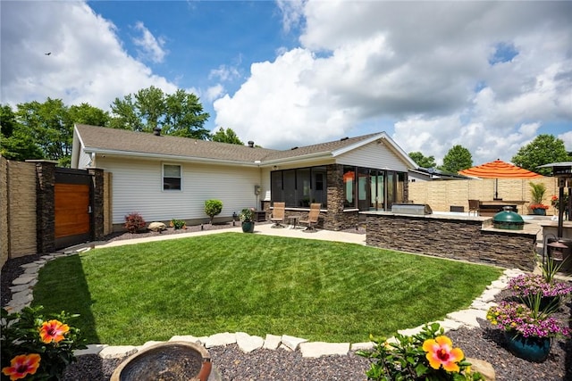 1003 Flame Ave, Effingham, IL 62401 - rear view of house with an outdoor kitchen, a patio area, and stone siding