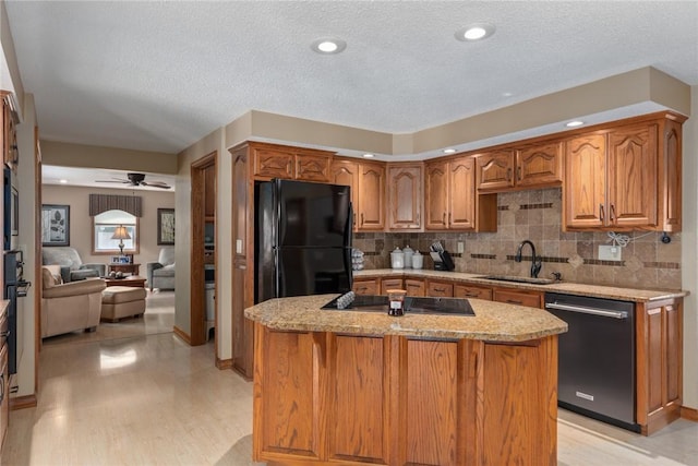 1003 Flame Ave, Effingham, IL 62401 - kitchen featuring black appliances, light stone countertops, backsplash, a ceiling fan, and brown cabinets