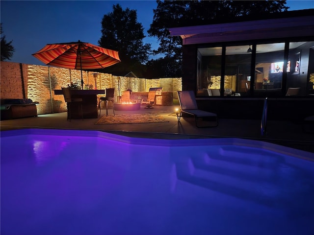 1003 Flame Ave, Effingham, IL 62401 - pool at night featuring an outdoor fire pit and a patio area