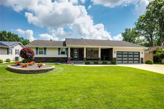 1003 Flame Ave, Effingham, IL 62401 - view of front facade featuring stone siding, a garage, driveway, and covered porch