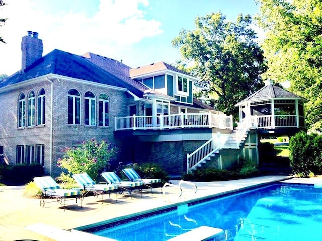 rear view of house featuring a gazebo and a patio area