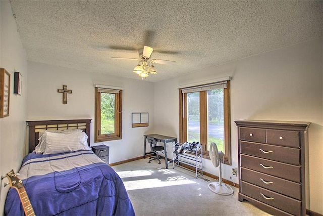bedroom featuring baseboards, carpet flooring, and a textured ceiling