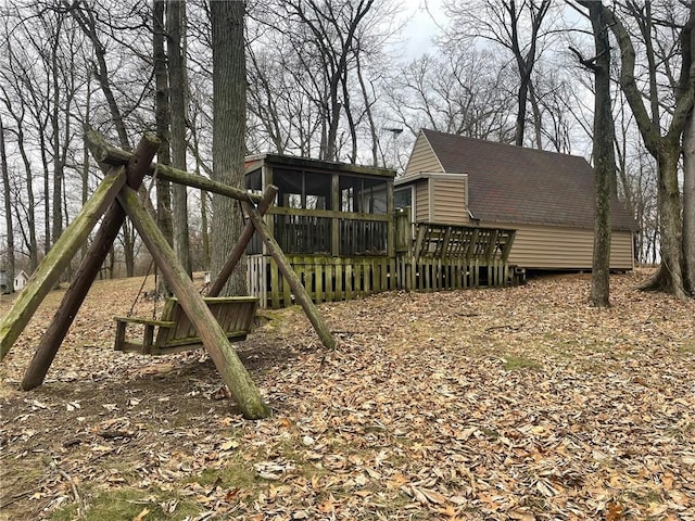 view of yard featuring a sunroom and a deck