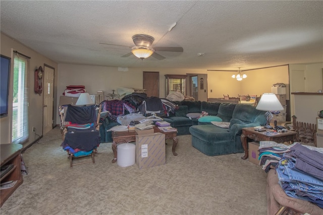 carpeted living room featuring ceiling fan with notable chandelier and a textured ceiling