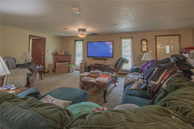 living room with light carpet, a textured ceiling, and ceiling fan