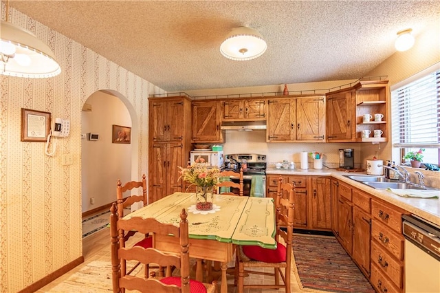 1059 Columbia Dr, Decatur, IL 62522 - kitchen featuring white appliances, wallpapered walls, light wood-style floors, under cabinet range hood, and a textured ceiling