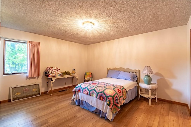 1059 Columbia Dr, Decatur, IL 62522 - bedroom with light wood finished floors and a textured ceiling