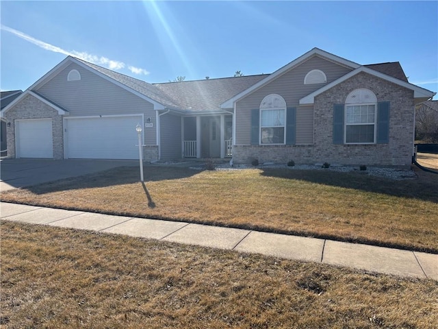 single story home featuring an attached garage, brick siding, driveway, and a front yard