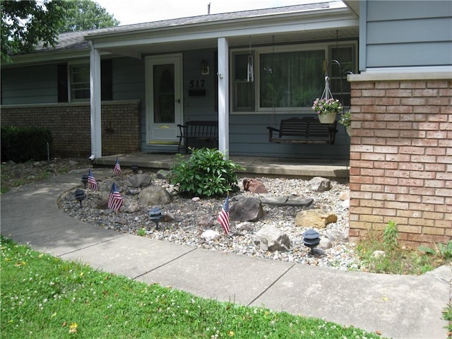 517 Coolidge Ave, Charleston, IL 61920 - property entrance featuring a porch and brick siding