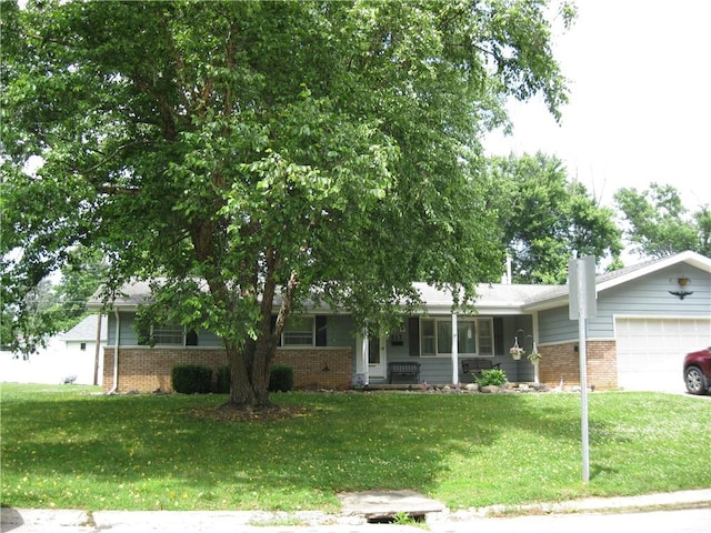 517 Coolidge Ave, Charleston, IL 61920 - view of front of home featuring brick siding, a garage, a front yard, and a chimney
