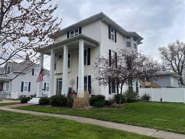 view of front of property with a front lawn and fence