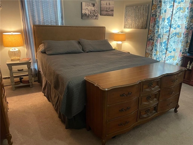 bedroom with light carpet and baseboard heating