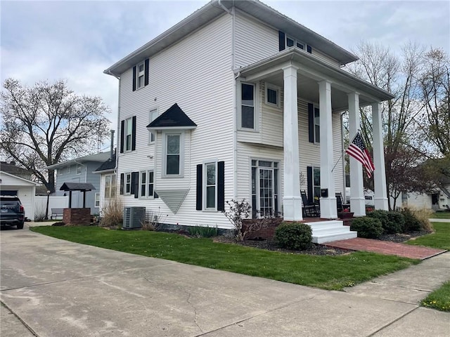 view of front of house featuring central AC unit and a front yard