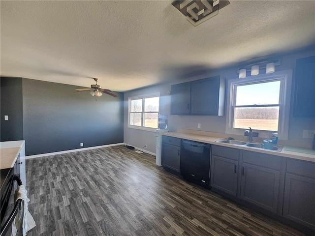 kitchen featuring dishwasher, light countertops, dark wood-style flooring, and a sink