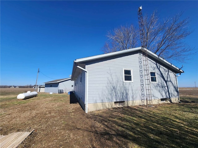 view of home's exterior with a yard