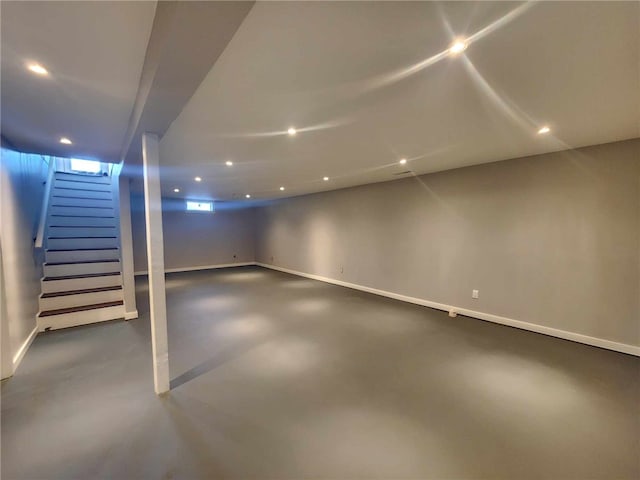 finished basement with recessed lighting, stairway, and baseboards