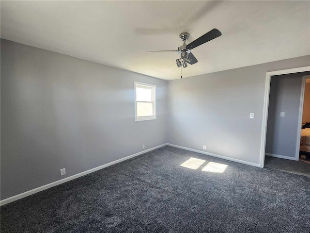 unfurnished room with a ceiling fan, baseboards, and carpet flooring