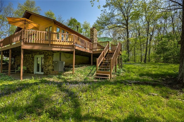 back of property featuring stairway, a deck, cooling unit, and french doors