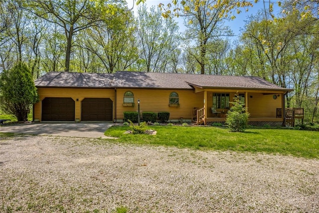 single story home featuring a garage, driveway, and a front yard