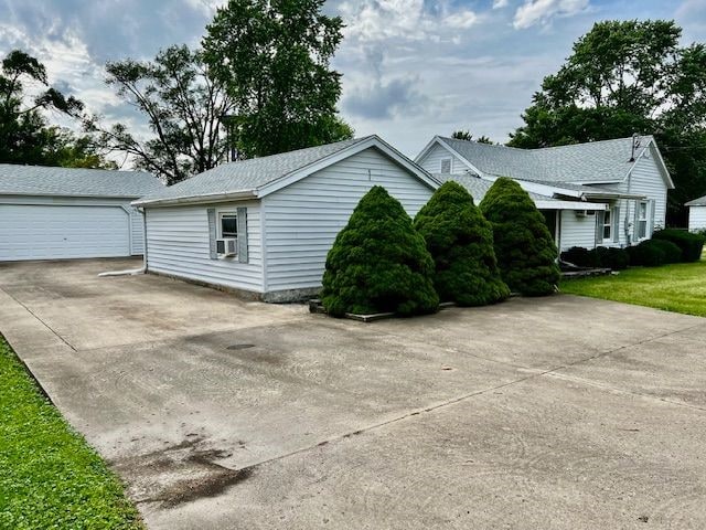 311 E Collett St, Oakwood, IL 61858 - view of side of property featuring a garage and cooling unit
