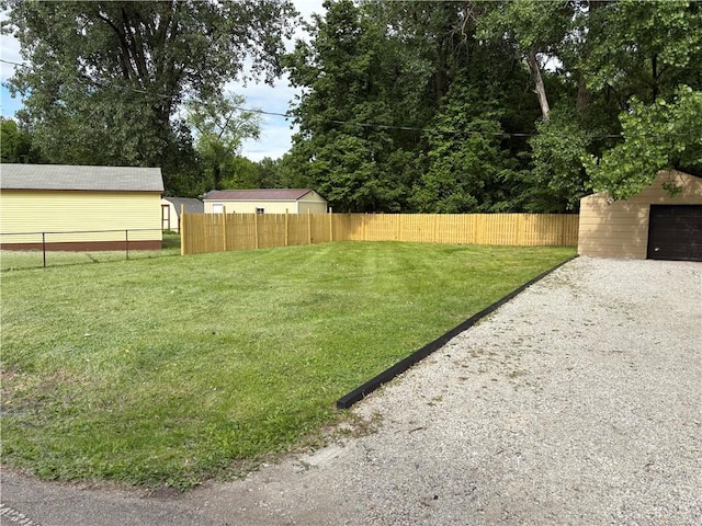 1404 N 24th St, Decatur, IL 62526 - view of yard featuring driveway, an outdoor structure, and a garage