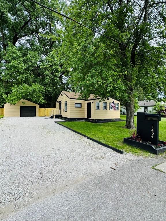 1404 N 24th St, Decatur, IL 62526 - view of front of home with an outdoor structure, a garage, and gravel driveway