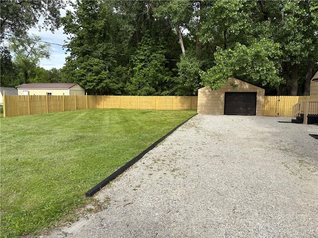 1404 N 24th St, Decatur, IL 62526 - view of yard with gravel driveway, an outdoor structure, and a garage