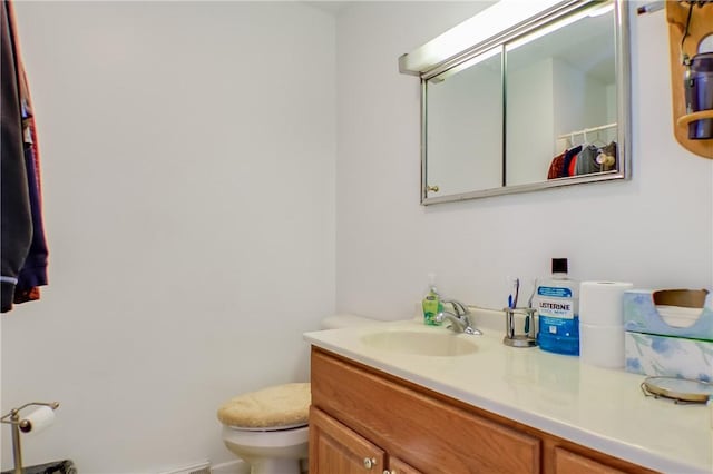 bathroom with toilet and vanity