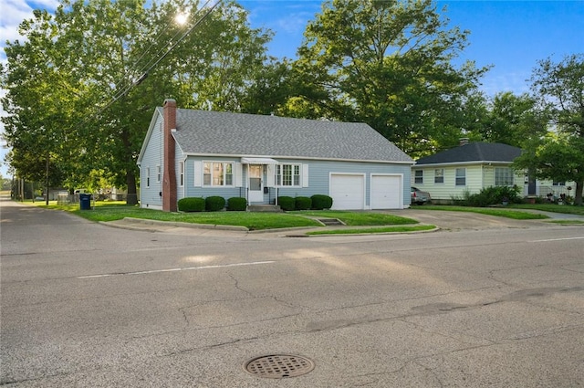 801 N Central Ave, Paris, IL 61944 - view of front of house with driveway, a chimney, and an attached garage