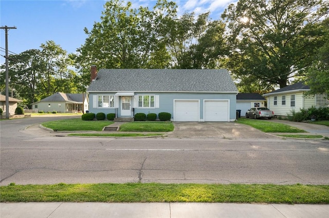 801 N Central Ave, Paris, IL 61944 - view of front of property featuring driveway, an attached garage, a chimney, and a front lawn