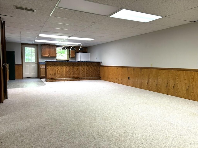 3002 N Charlotte St, Effingham, IL 62401 - carpeted spare room featuring wainscoting, a drop ceiling, wooden walls, and bar