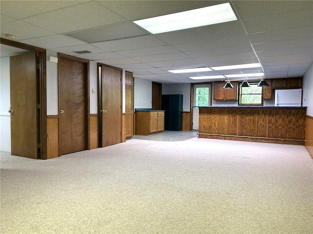 3002 N Charlotte St, Effingham, IL 62401 - empty room with a paneled ceiling, light carpet, wainscoting, and wooden walls