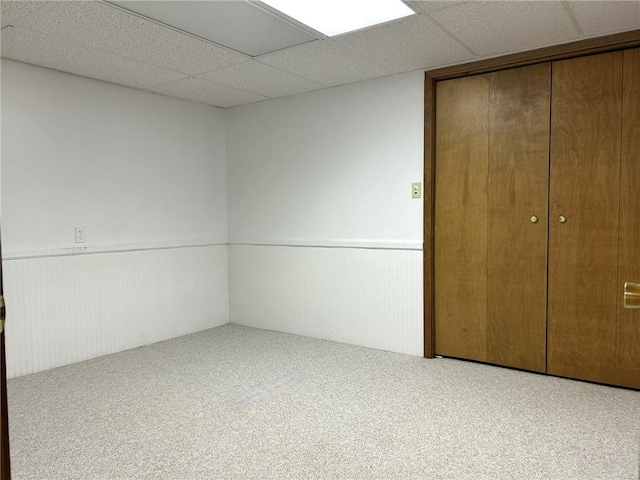 3002 N Charlotte St, Effingham, IL 62401 - unfurnished bedroom featuring a wainscoted wall, carpet floors, a closet, and a paneled ceiling