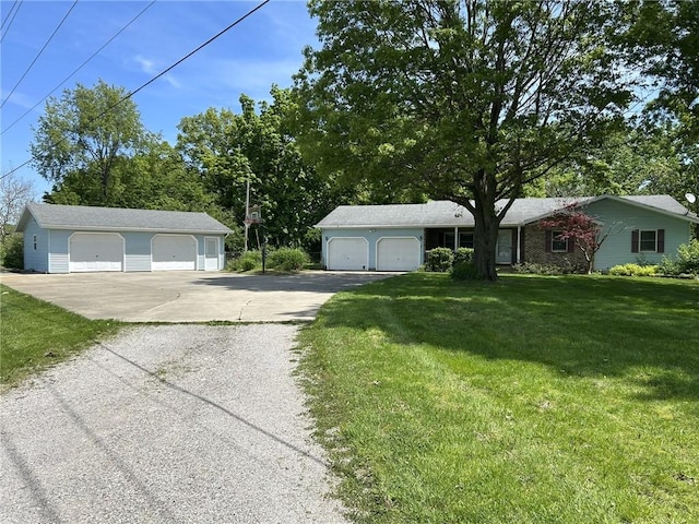 3002 N Charlotte St, Effingham, IL 62401 - view of front of house featuring a garage, a front lawn, and an outdoor structure