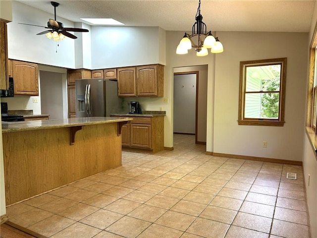 3002 N Charlotte St, Effingham, IL 62401 - kitchen with stainless steel fridge with ice dispenser, electric range oven, light tile patterned floors, a kitchen bar, and pendant lighting