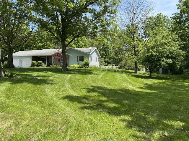 3002 N Charlotte St, Effingham, IL 62401 - view of green lawn with an attached garage, a storage shed, and an outdoor structure