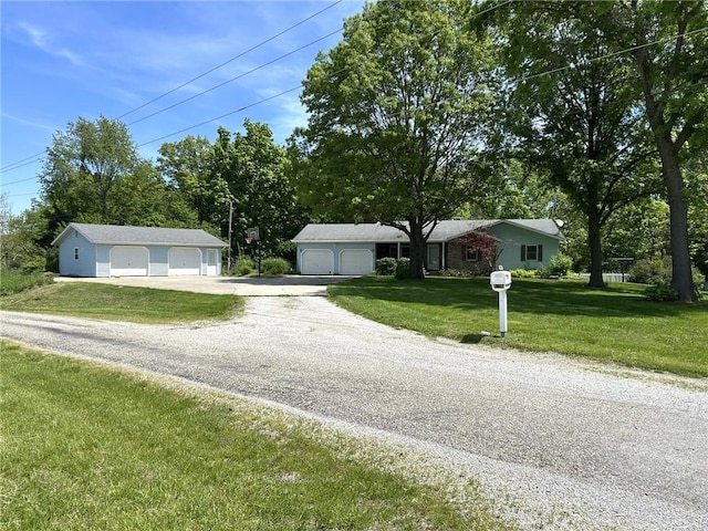3002 N Charlotte St, Effingham, IL 62401 - view of front of house with a garage, a front yard, gravel driveway, and view of scattered trees