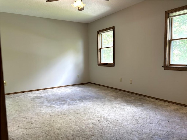 3002 N Charlotte St, Effingham, IL 62401 - unfurnished room featuring ceiling fan, healthy amount of natural light, carpet, baseboards, and a textured ceiling