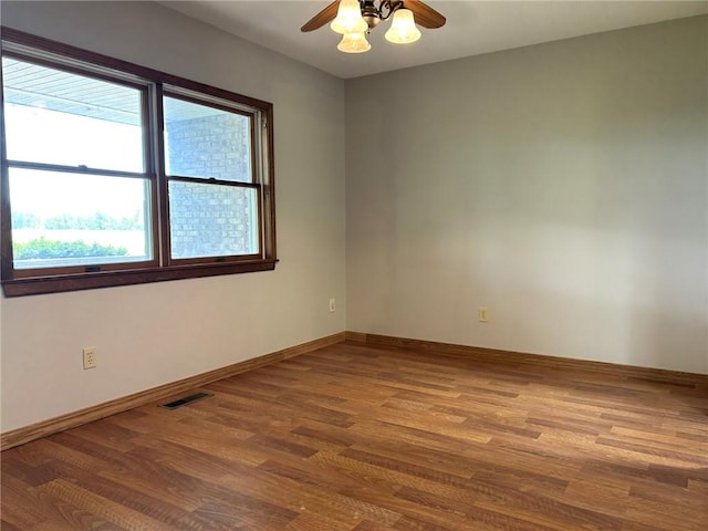 3002 N Charlotte St, Effingham, IL 62401 - spare room featuring wood finished floors, ceiling fan, and baseboards
