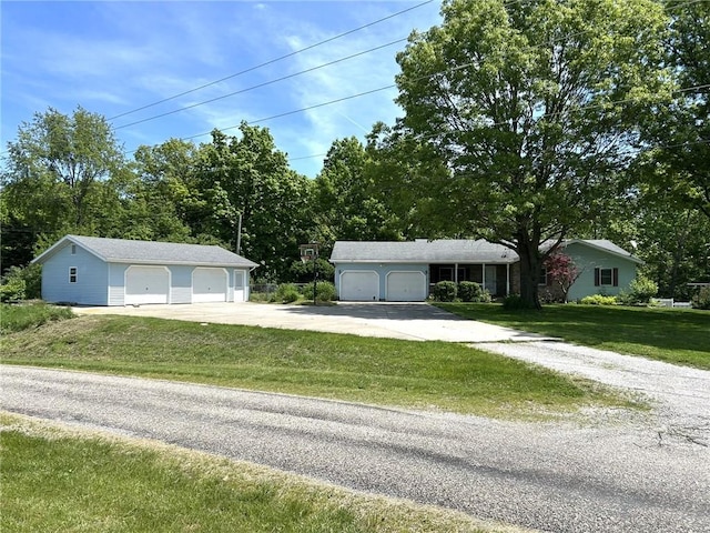 3002 N Charlotte St, Effingham, IL 62401 - view of front of property featuring a front yard, a garage, an outdoor structure, and view of scattered trees