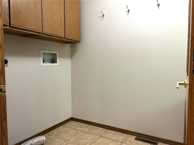 3002 N Charlotte St, Effingham, IL 62401 - clothes washing area featuring cabinet space, hookup for an electric dryer, baseboards, washer hookup, and light tile patterned floors