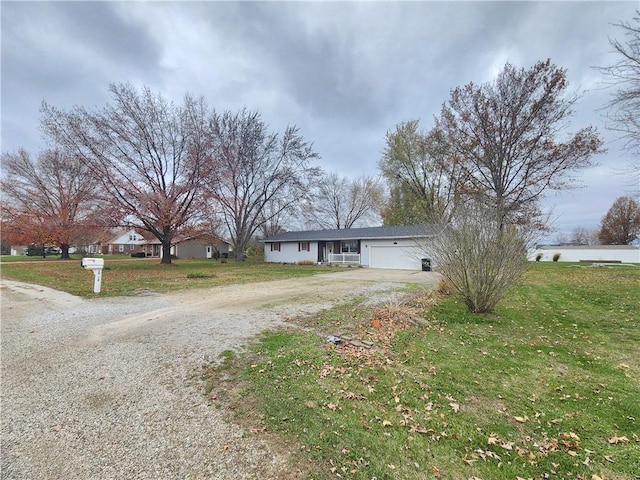 single story home with a front yard and a garage