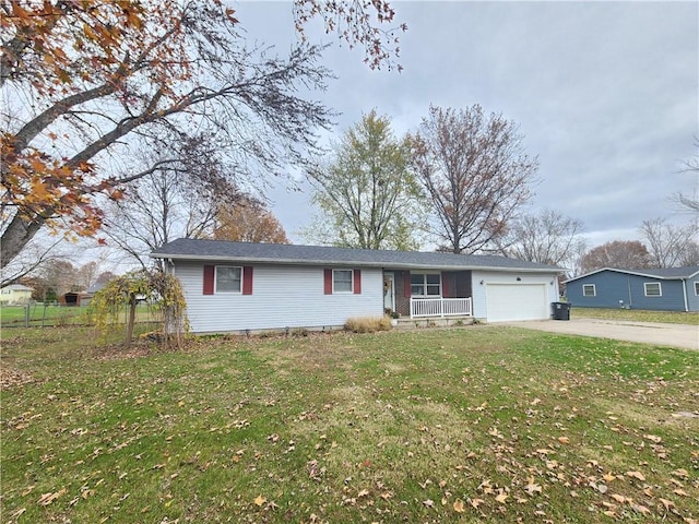 ranch-style house with a front yard, a garage, and covered porch