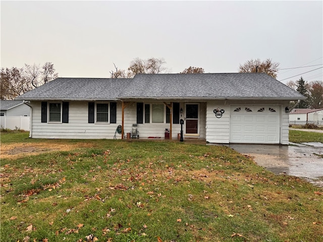 single story home with an attached garage, driveway, a front lawn, and roof with shingles