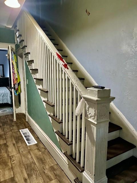 stairway featuring hardwood / wood-style floors