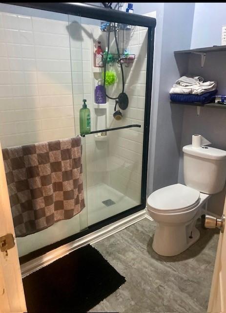 bathroom featuring toilet and walk in shower