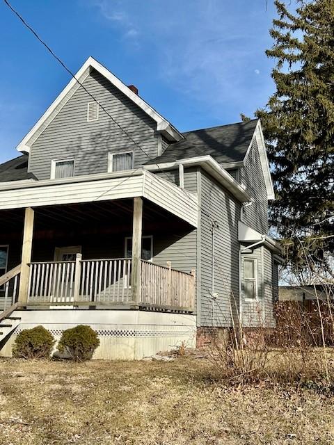 view of property exterior with covered porch