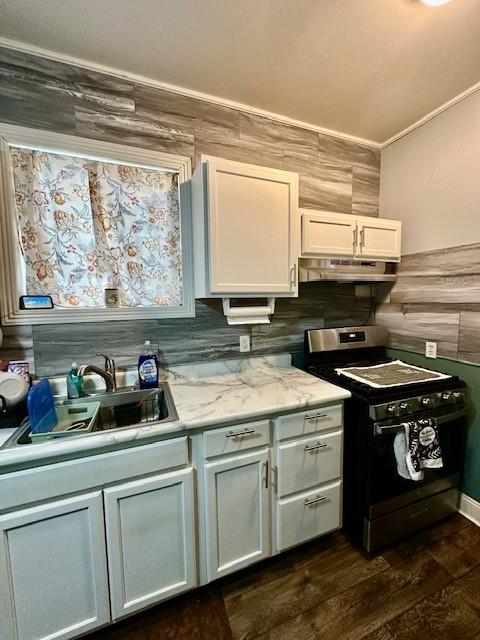 kitchen featuring dark wood-type flooring, range with gas stovetop, sink, and white cabinets